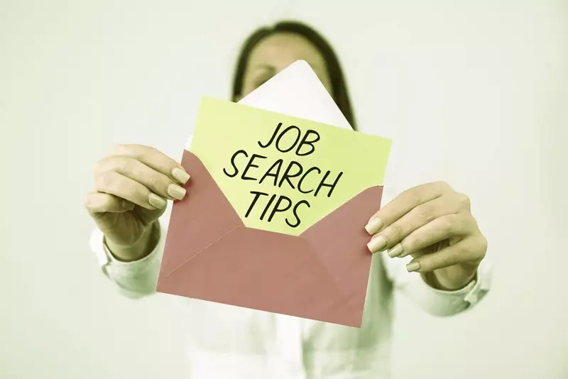 Person holding an open envelope with a card inside that reads 